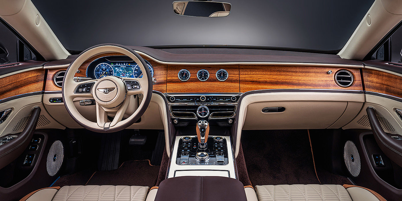 Bentley Baku Bentley Flying Spur Odyssean sedan front interior in Open Pore Koa veneer with Piano Linen console and Linen and Burnt Oak hides