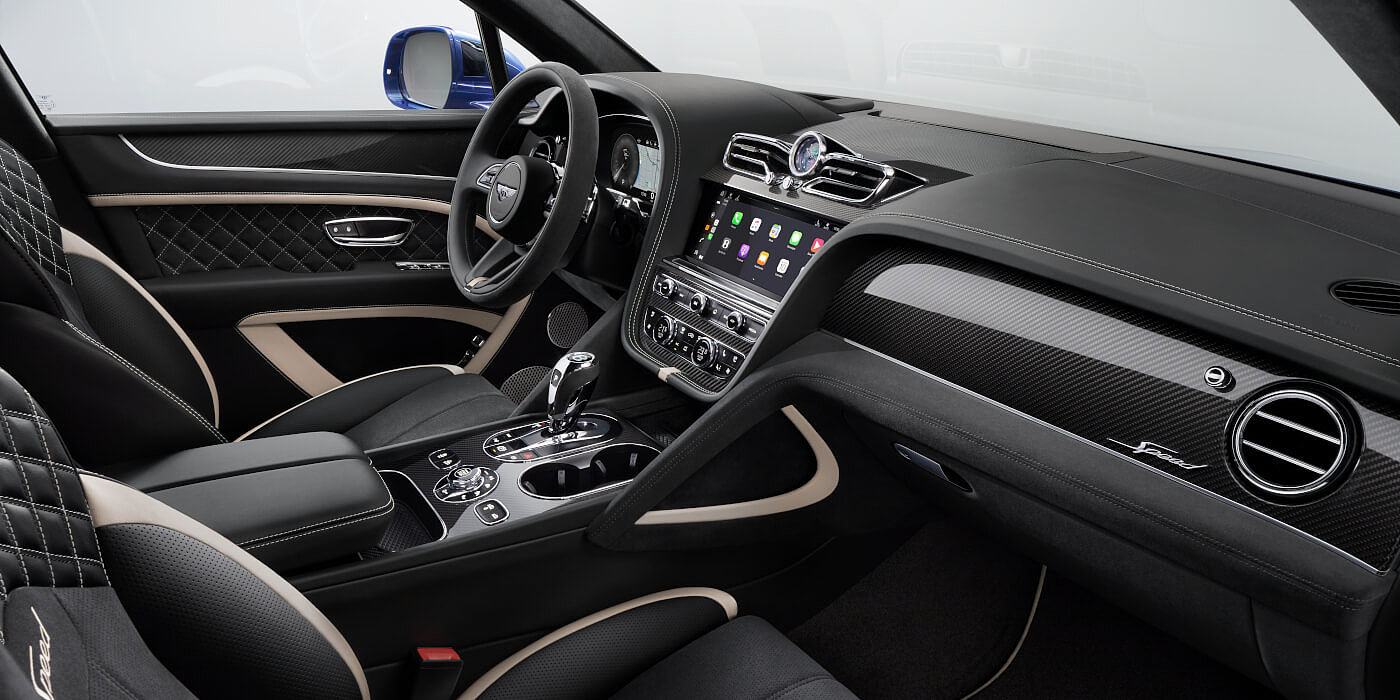 Bentley Baku Bentley Bentayga Speed SUV front interior in Beluga black and Linen hide with carbon fibre veneer