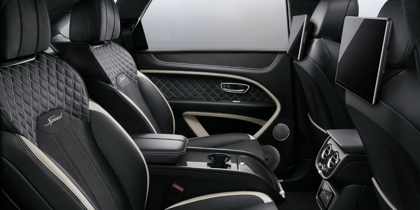 Bentley Baku Bentley Bentayga Speed SUV rear interior in Beluga black and Linen hide with carbon fibre veneer