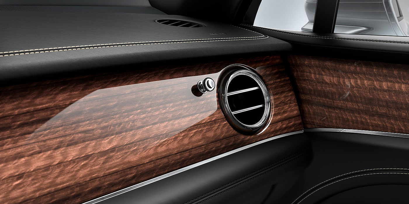 Bentley Baku Bentley Bentayga front interior Crown Cut Walnut veneer and chrome air vent.