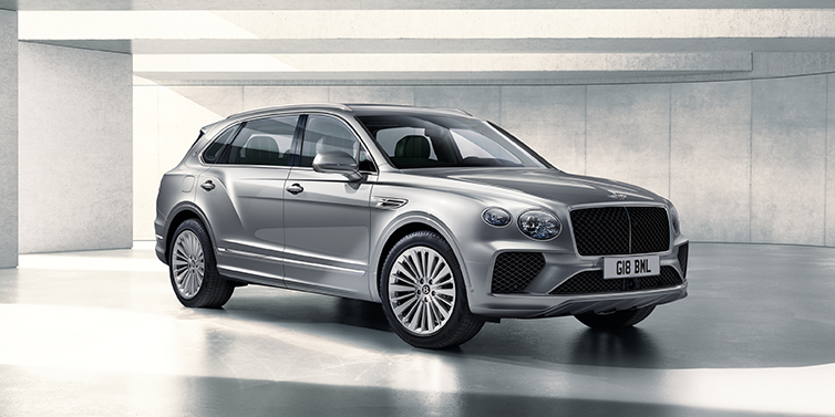 Bentley Baku Bentley Bentayga Extended Wheelbase SUV front three quarter in Moonbeam paint with a grey background